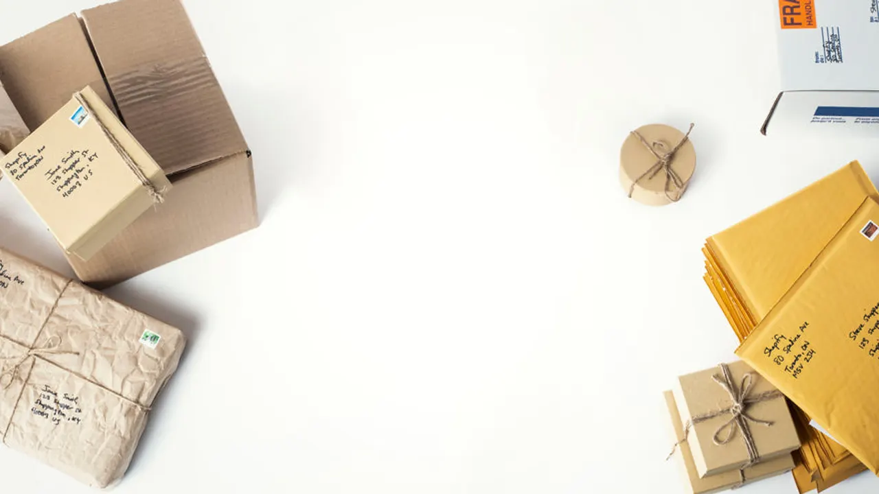 Flatlay of boxes and envelopes on table.