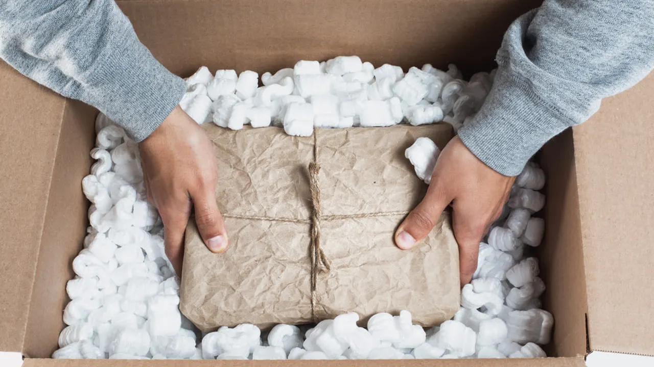 Placing a package in packing material.