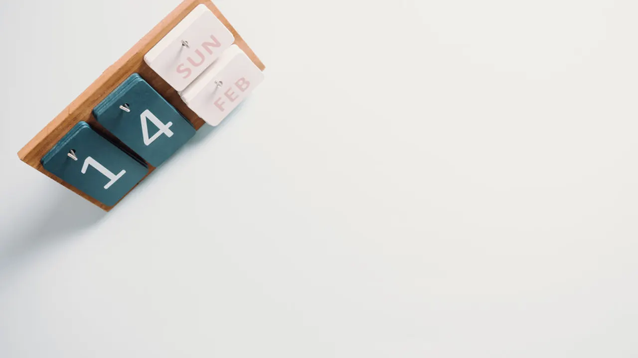 Wooden calendar sits on a white background.