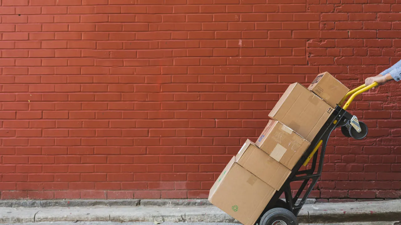 Shipping boxes in front of red brick.