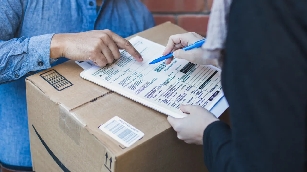 Signing shipping forms for large box.