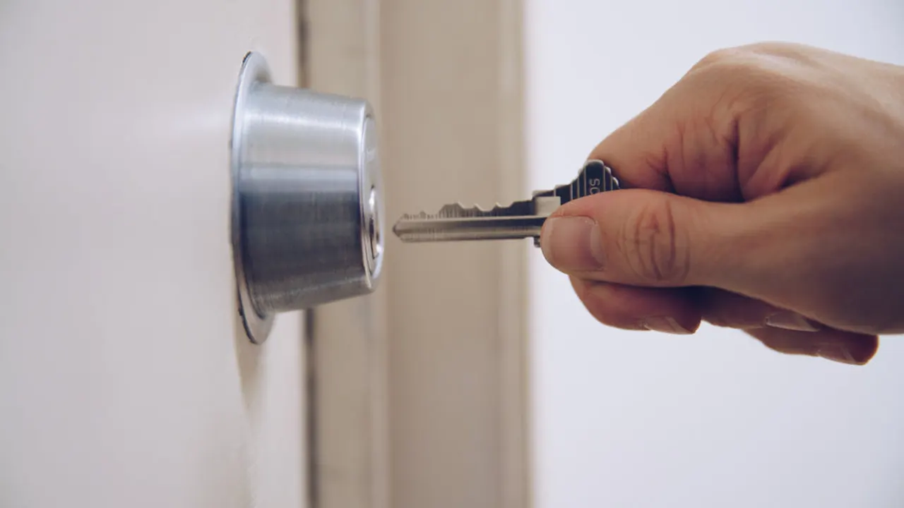 Key to padlock in hand.