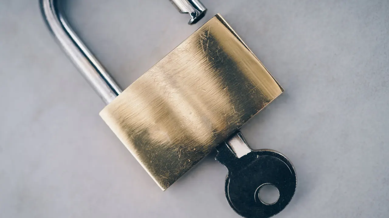 Padlock with key close up.