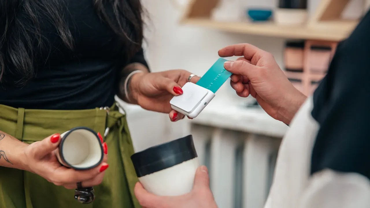 Merchant taking sale with chip and swipe reader.